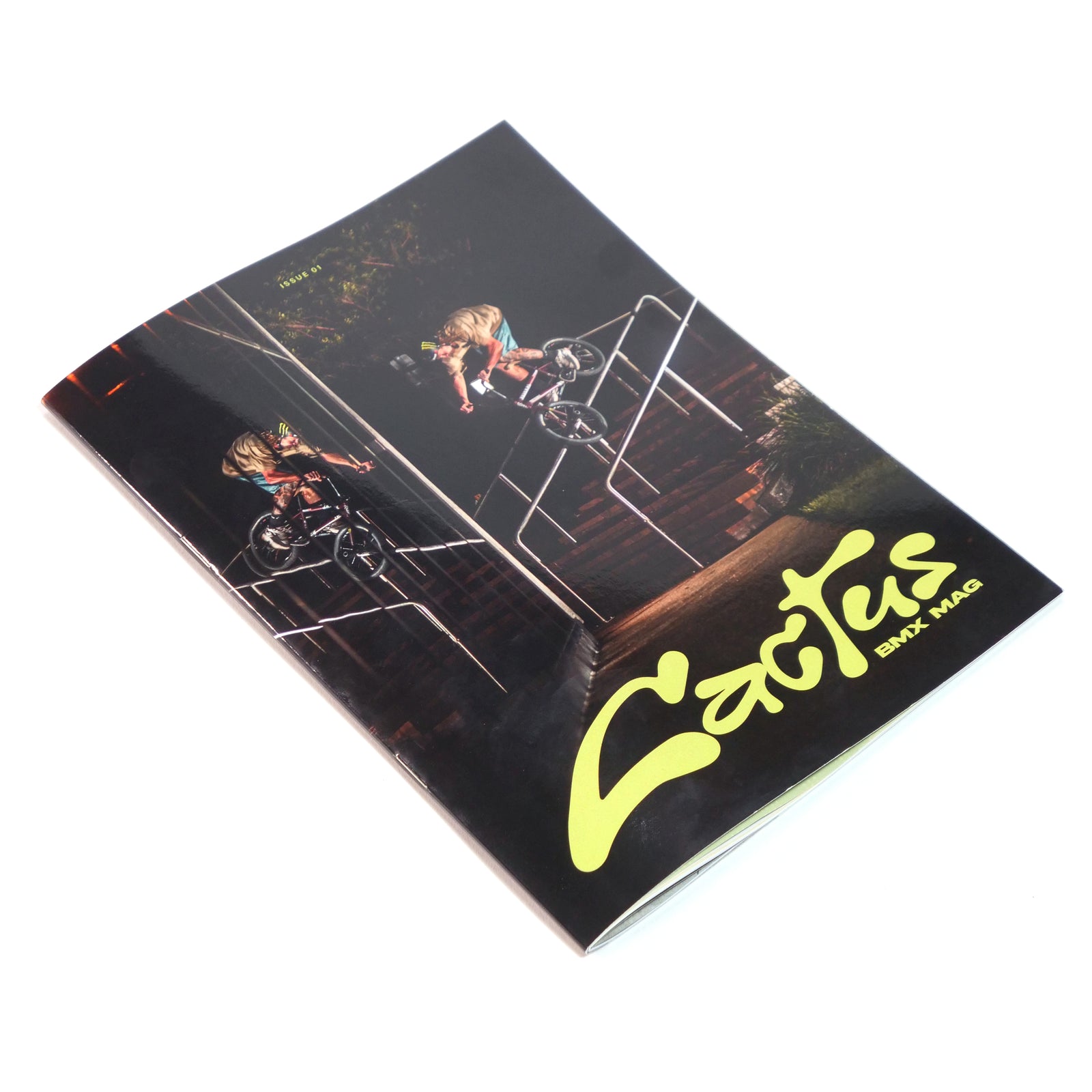 A printed copy of Cactus BMX Mag Issue 01 lying on a white surface, Boyd Hilder's handrail smith on the cover.