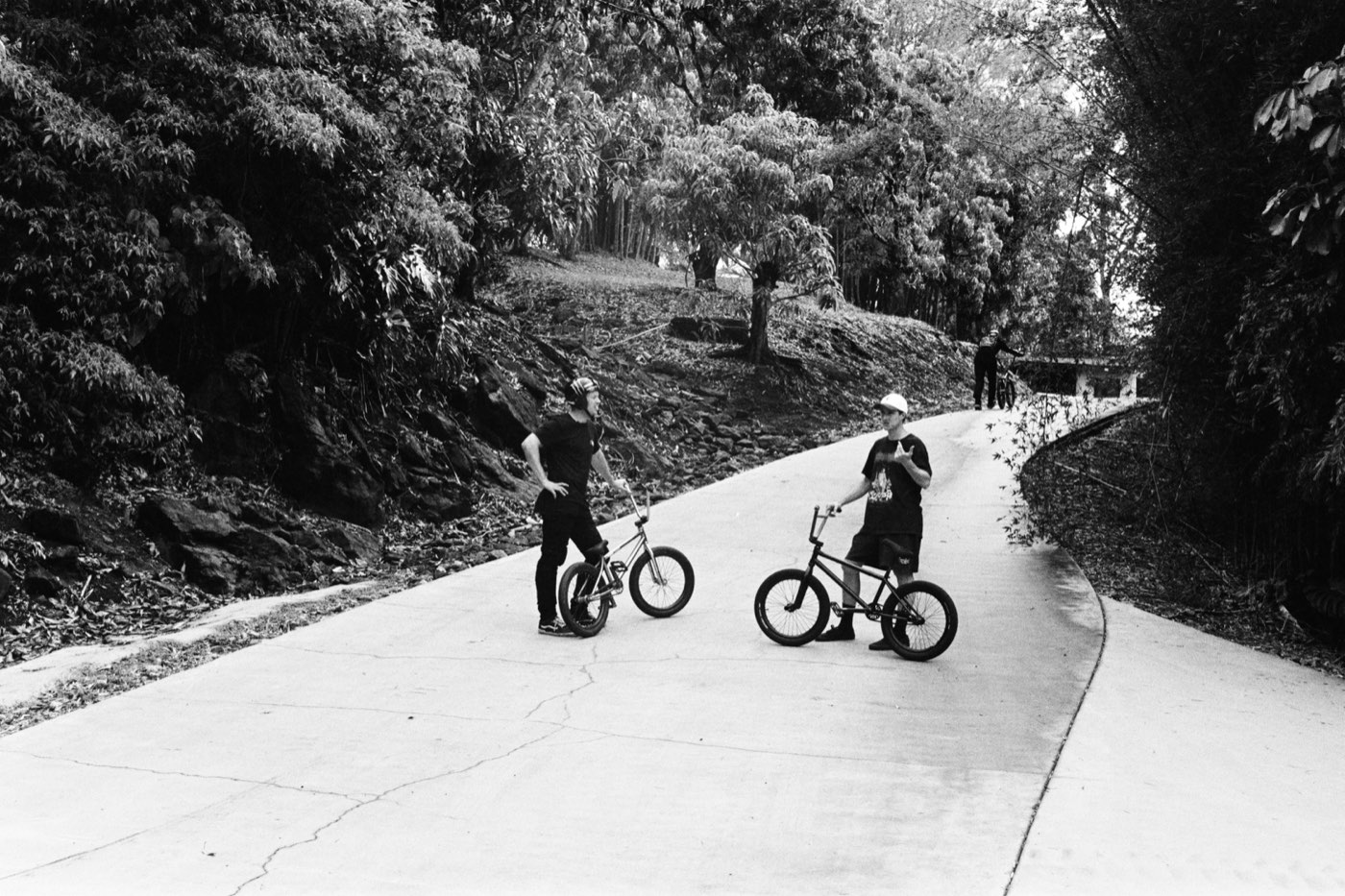 Ryan and Mike stopped on the concrete driveway with their bikes.