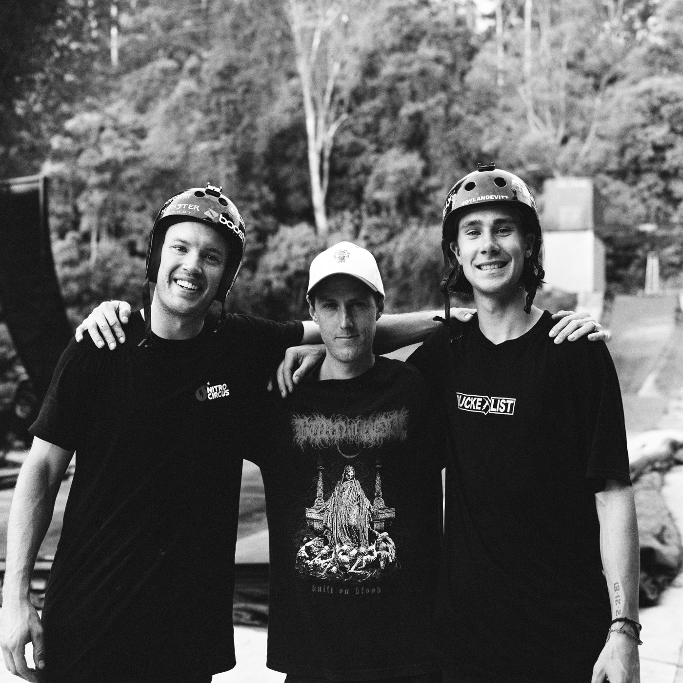 Ryan, Mike and Dylan Devitt with arms around each other in front of the ramps.